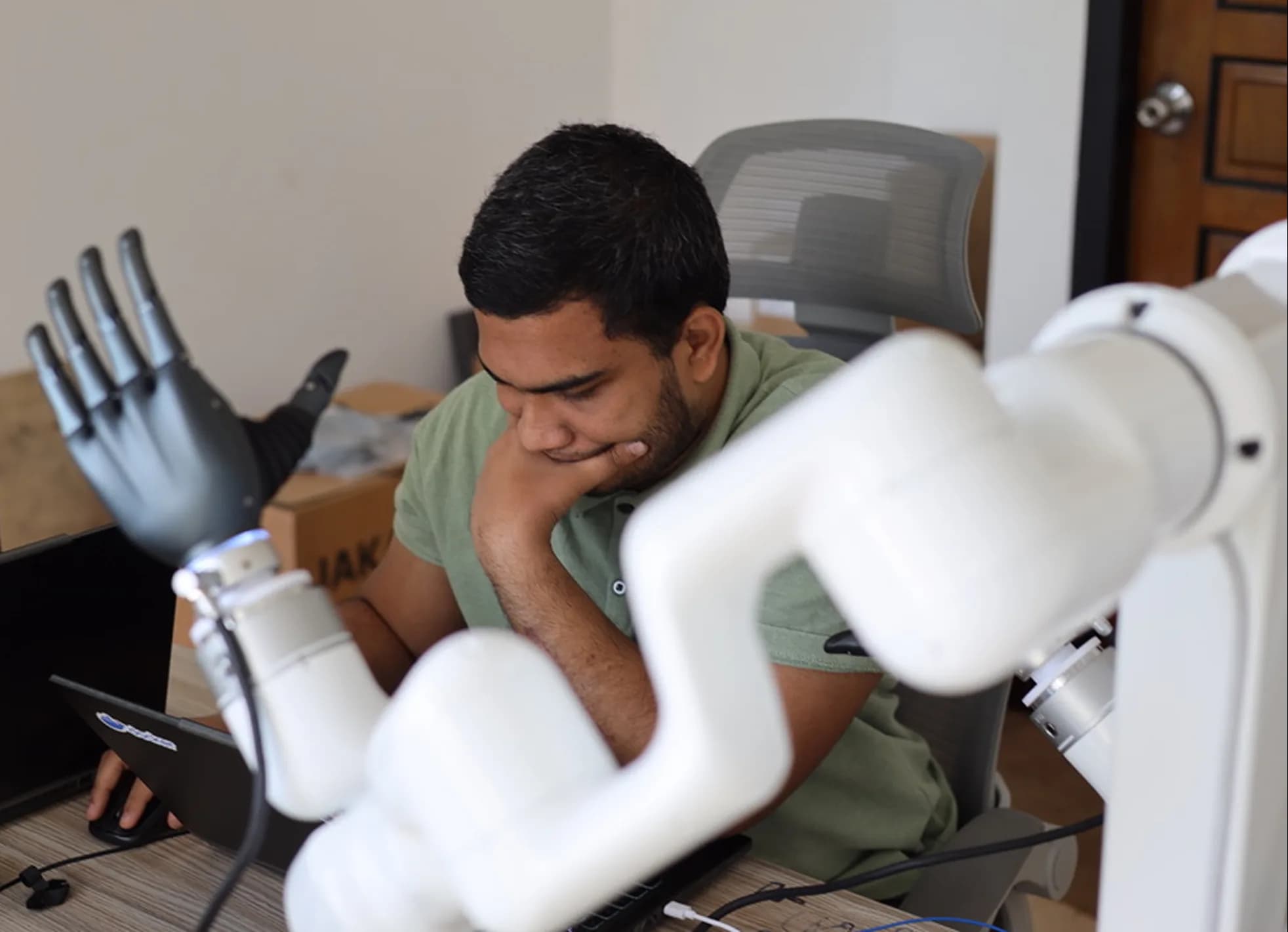 Engineer inspecting a robotic mechanism or simulation environment